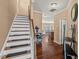 Inviting foyer with hardwood floors, staircase, and views into the living spaces at 2216 Tanners Mill Dr, Durham, NC 27703