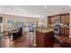 Open-concept living room and kitchen area featuring hardwood floors and natural light at 2216 Tanners Mill Dr, Durham, NC 27703