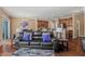 Comfortable living room with a plush sofa, hardwood floors, and a view of the kitchen at 2216 Tanners Mill Dr, Durham, NC 27703