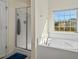 Spa-like bathroom showcasing a soaking tub, walk-in shower, and natural light at 2216 Tanners Mill Dr, Durham, NC 27703