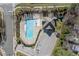 Overhead shot of a community pool featuring a distinct design, shaded seating, and ample parking at 2216 Tanners Mill Dr, Durham, NC 27703