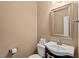 Well-lit powder room with a stylish vanity, mirror, and convenient toilet paper holder at 2216 Tanners Mill Dr, Durham, NC 27703