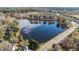 A gorgeous aerial view showing a lake surrounded by homes, reflecting the cloudy blue sky at 2245 Ventana Ln, Raleigh, NC 27604
