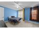 Cozy bedroom with a ceiling fan, blue walls, carpet and natural light from the windows at 2245 Ventana Ln, Raleigh, NC 27604
