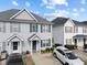 Charming townhome featuring blue shutters, a well-kept lawn, and a private driveway at 2245 Ventana Ln, Raleigh, NC 27604