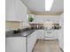 Well-lit kitchen with white cabinetry, granite countertops, and modern appliances at 2245 Ventana Ln, Raleigh, NC 27604