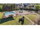 An aerial view of a playground with swings, slides, and other play structures, featuring multiple shaded canopy areas at 2245 Ventana Ln, Raleigh, NC 27604
