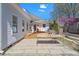 Expansive backyard with a wooden deck, stone patio, and charming white-washed house at 2330 Glascock St, Raleigh, NC 27610