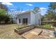 View of the backyard with raised garden beds and a modern outbuilding featuring sliding glass doors at 2330 Glascock St, Raleigh, NC 27610