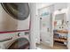 Contemporary bathroom featuring a glass shower, sleek fixtures, and a convenient washer/dryer at 2330 Glascock St, Raleigh, NC 27610