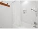 Bathroom features a white tiled wall, a bathtub, and a white shower curtain at 2330 Glascock St, Raleigh, NC 27610