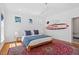 Bright bedroom with hardwood floors, unique decor, and three windows allowing natural light at 2330 Glascock St, Raleigh, NC 27610