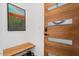 Modern entryway with a wood door, a bench, and a contemporary art piece at 2330 Glascock St, Raleigh, NC 27610