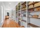 Bright hallway with custom built-in shelving, hardwood floors, and an open floor plan at 2330 Glascock St, Raleigh, NC 27610
