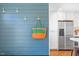 Close up of kitchen entrance with stainless appliances and a colorful wall hanging at 2330 Glascock St, Raleigh, NC 27610