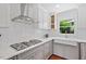 This kitchen showcases custom cabinetry, subway tile backsplash, and a stainless steel range hood at 2330 Glascock St, Raleigh, NC 27610