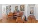 Well-appointed living room shows hardwood floors, piano, and a sitting area enhanced by natural light at 2330 Glascock St, Raleigh, NC 27610