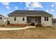 The back of the house features a covered porch and a grassy lawn on a sunny day at 240 Northview Dr, Middlesex, NC 27557