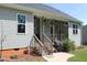 Spacious backyard featuring a porch, lush grass, a pathway, and ample greenery at 240 Northview Dr, Middlesex, NC 27557