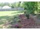 Lush backyard with a beautiful garden along a wooden fence line at 240 Northview Dr, Middlesex, NC 27557