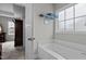 Bright bathroom features a soaking tub, a window, and access to the main bedroom at 240 Northview Dr, Middlesex, NC 27557