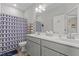 Bathroom with a double sink vanity, a shower with a patterned curtain and tiled floors at 240 Northview Dr, Middlesex, NC 27557