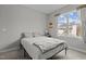 Bright bedroom with a large window and a cozy bed dressed in a white duvet and gray throw at 240 Northview Dr, Middlesex, NC 27557