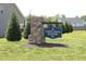 Community sign reading North Creek Meadows in a well landscaped neighborhood with grassy areas and trees at 240 Northview Dr, Middlesex, NC 27557