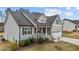 Attractive two-story home with covered porch, 2-car garage, and manicured landscaping at 240 Northview Dr, Middlesex, NC 27557