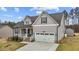 Inviting two-story home featuring a covered porch, two-car garage, and a beautifully landscaped front yard at 240 Northview Dr, Middlesex, NC 27557