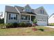 Beautiful two-story home with a covered front porch, well-maintained lawn, and a two-car garage at 240 Northview Dr, Middlesex, NC 27557