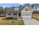 Charming home featuring a 2-car garage, inviting front porch, manicured lawn, and stylish exterior finishes at 240 Northview Dr, Middlesex, NC 27557