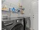 Well-organized laundry room with modern washer and dryer units and plenty of storage shelves at 240 Northview Dr, Middlesex, NC 27557