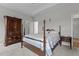 Comfortable main bedroom featuring a four-poster bed, armoire, and a nightstand at 240 Northview Dr, Middlesex, NC 27557