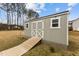 A charming storage shed features classic white trim, and a ramp for easy access at 240 Northview Dr, Middlesex, NC 27557