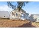 Back exterior featuring horizontal siding, a small yard, and simple landscaping at 2613 Lilymount Dr, Raleigh, NC 27610