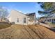 Exterior backyard with vinyl siding, a small deck and lawn at 2613 Lilymount Dr, Raleigh, NC 27610