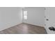 Neutral bedroom features updated flooring, natural light, and a closet at 2613 Lilymount Dr, Raleigh, NC 27610