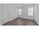 Bedroom with neutral walls, updated flooring, and natural light at 2613 Lilymount Dr, Raleigh, NC 27610
