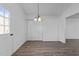 Dining room with hardwood floors and a modern light fixture at 2613 Lilymount Dr, Raleigh, NC 27610