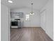 Open kitchen featuring gray cabinets, updated appliances, and wood-look flooring at 2613 Lilymount Dr, Raleigh, NC 27610