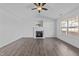 Spacious living room with hardwood floors, vaulted ceiling, and a cozy fireplace at 2613 Lilymount Dr, Raleigh, NC 27610