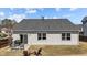 Back exterior with sliding glass door, outdoor seating, grill, and well-maintained siding at 2914 Lake James Dr, Fuquay Varina, NC 27526