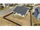 Aerial view of fenced backyard featuring patio seating, a fire pit, and a well-kept lawn at 2914 Lake James Dr, Fuquay Varina, NC 27526