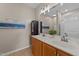 Bright bathroom featuring a double sink vanity with white countertops and a decorative seascape painting at 2914 Lake James Dr, Fuquay Varina, NC 27526