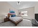 Comfortable bedroom with a wooden bed frame, ceiling fan, and natural light from a window at 2914 Lake James Dr, Fuquay Varina, NC 27526
