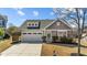 Charming home featuring stone accents, an attached two-car garage, and a well-manicured lawn at 2914 Lake James Dr, Fuquay Varina, NC 27526