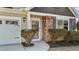 Inviting front entrance with stone accents, decorative shrubbery, and charming lighting at 2914 Lake James Dr, Fuquay Varina, NC 27526
