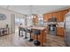 Spacious kitchen featuring an island with seating, wood cabinets, and stainless steel appliances at 2914 Lake James Dr, Fuquay Varina, NC 27526