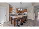 Well-appointed kitchen featuring a center island, wood cabinets, and stylish pendant lighting at 2914 Lake James Dr, Fuquay Varina, NC 27526